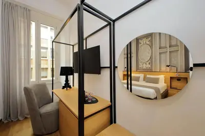 a hotel room with a bed and a mirror at Youroom Abruzzi in Rome
