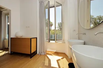a bathroom with a tub and a sink and a mirror at Youroom Abruzzi in Rome