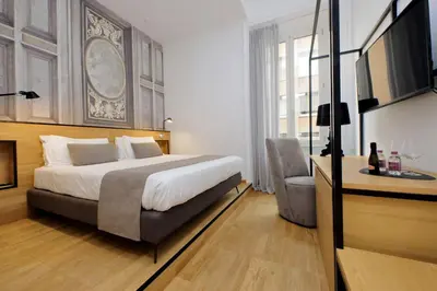 a hotel room with a bed and a chair at Youroom Abruzzi in Rome