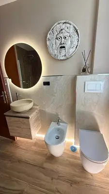 a living room with a table and a mirror at Colosseo Room in Rome