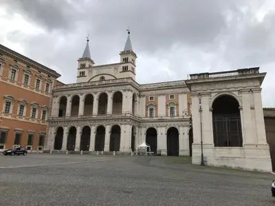 a large building with a tower on top of it at Colosseo Room in Rome