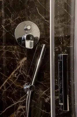 a shower with a glass door with a shower at Almaìt in Rome