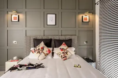 a bedroom with a white bed with four pillows at Almaìt in Rome