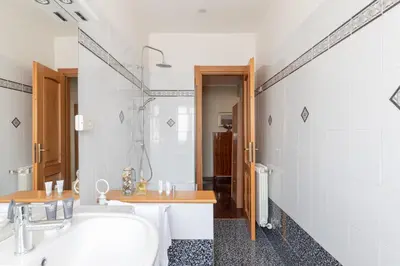 a white bathroom with a sink and a toilet at Vatican Cozy Apartment with Terrace in Rome