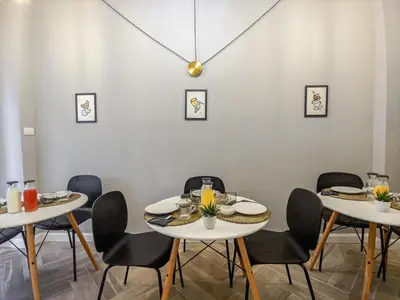 a dining room with white tables and black chairs at Otium Fornaci San Pietro Vaticano Castel Sant'Angelo in Rome