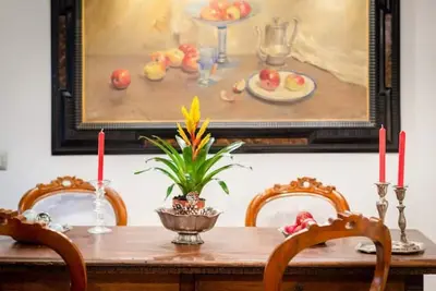 a dining room table with two chairs and a painting at Sistina House Style HolidayHome x 6 in Rome