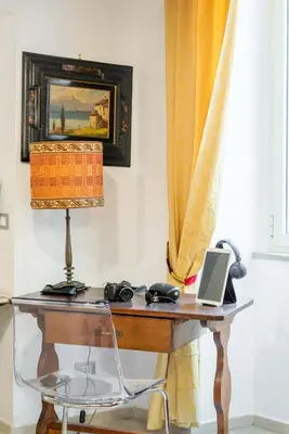 a desk with a laptop and a lamp on it at Sistina House Style HolidayHome x 6 in Rome