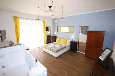 a bedroom with a bed and a bathroom with a mirror at Unique luxury apartment and rooms in Rome