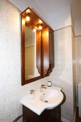 a bathroom with a sink and a mirror at Unique luxury apartment and rooms in Rome