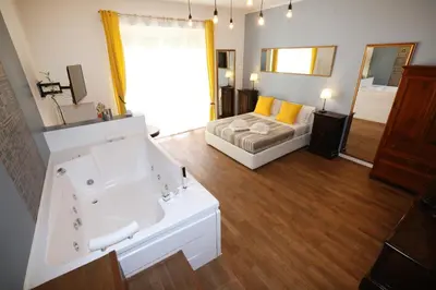 a bathroom with a tub and a sink and a bed at Unique luxury apartment and rooms in Rome