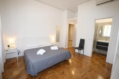 a bedroom with a bed and a desk and a chair at Unique luxury apartment and rooms in Rome