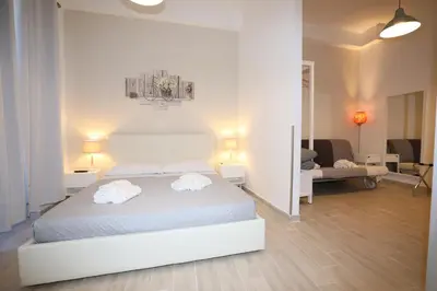 a bedroom with a bed with two towels on it at Unique luxury apartment and rooms in Rome