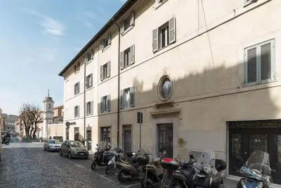 a group of motorcycles parked in front of a building at GuestHost - Colosseo & San Clemente Cozy Flat in Rome