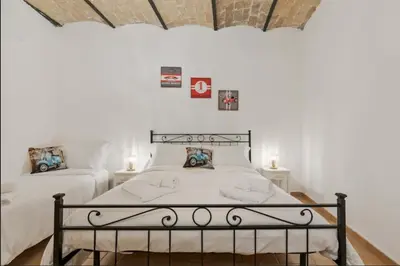 a bedroom with a bed and two night stands at Roma Colosseum Apartment in Rome