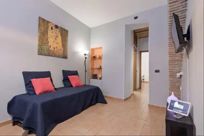 a bedroom with a bed with red pillows on it at Roma Colosseum Apartment in Rome