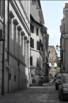 an alley with buildings and cars on a street at Roma Colosseum Apartment in Rome