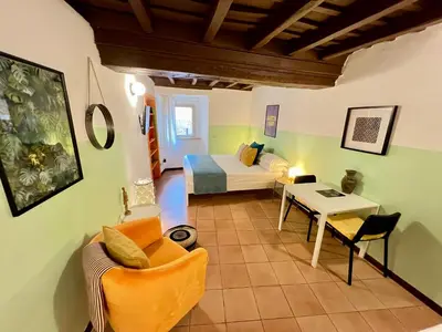a living room with a bed and a table at Charming Campo de' Fiori in Rome
