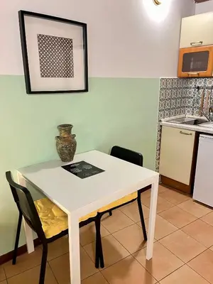 a white table and chairs in a kitchen at Charming Campo de' Fiori in Rome