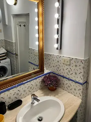 a bathroom with a sink and a mirror at Charming Campo de' Fiori in Rome