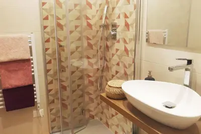 a bathroom with a sink and a shower at Rome Labicana Apartment in Rome