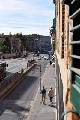 a group of people walking down a city street at Rome Labicana Apartment in Rome