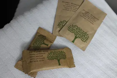 two brown paper bags with trees on a towel at Roma suite Piramide in Rome