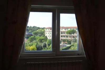 a window with a view of a building at Mons Aureus Resort in Rome