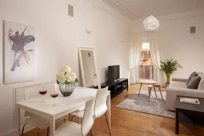 a living room with a white table with wine glasses at Daplace - Matilde Apartment in Rome