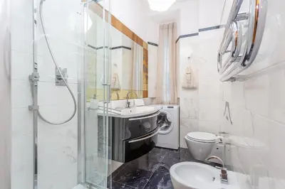 a bathroom with a toilet and a sink and a shower at Daplace - Matilde Apartment in Rome