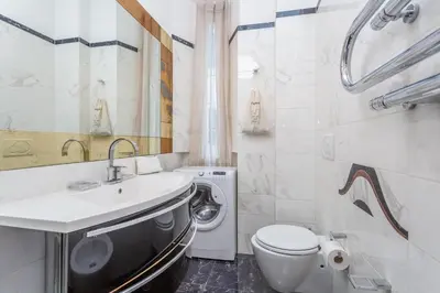 a bathroom with a sink and a washing machine at Daplace - Matilde Apartment in Rome