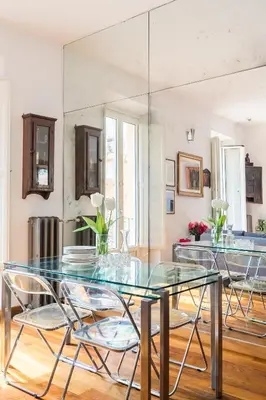 a dining room with a glass table and chairs at R.C. Cappellari Charming Campo de Fiori in Rome