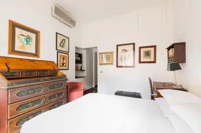 a bedroom with a bed and a dresser at R.C. Cappellari Charming Campo de Fiori in Rome