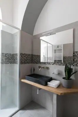 a bathroom with a sink and a shower and a mirror at Horti Sallustiani Roma in Rome