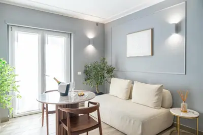 a living room with a couch and a table at Nouvelle Maison Rome Luxury Palace in Rome