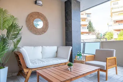 a patio with a couch and a table on a balcony at Nouvelle Maison Rome Luxury Palace in Rome
