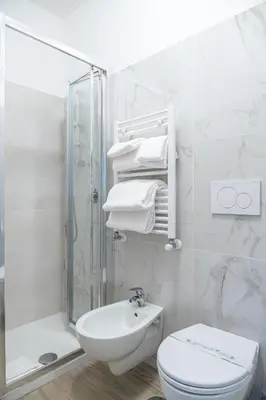 a bathroom with a toilet and a shower and a sink at Nouvelle Maison Rome Luxury Palace in Rome