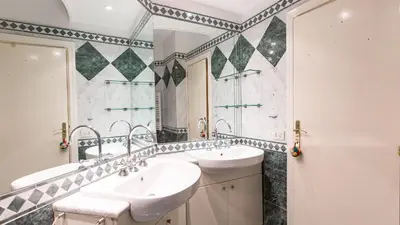 a bathroom with two sinks and a large mirror at Rental in Rome Scala Deluxe in Rome