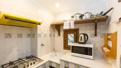 a kitchen with a microwave and a sink at Rental in Rome Scala Deluxe in Rome