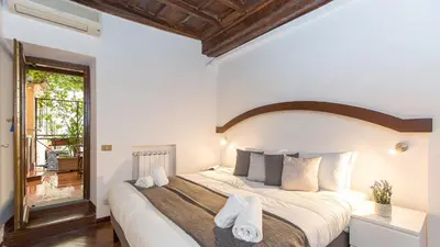 a bedroom with a large bed with towels on it at Rental in Rome Scala Deluxe in Rome