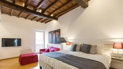a bedroom with a large bed and a tv at Rental in Rome Trastevere Atmosphere in Rome