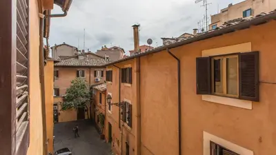 an alley in an old town with buildings at Rental in Rome Trastevere Atmosphere in Rome