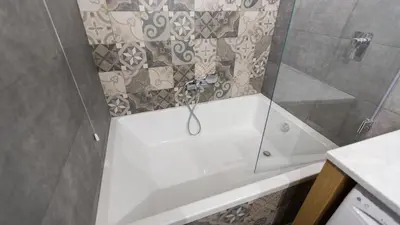 a bathroom with a shower with a glass door at Rental in Rome Trastevere Atmosphere in Rome