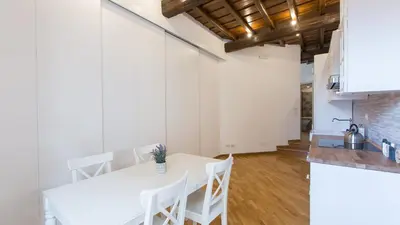 a kitchen and dining room with a white table and chairs at Rental in Rome Trastevere Atmosphere in Rome