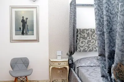 a bedroom with a bed and a picture of a couple at Merulana Suite S.Peter in Rome