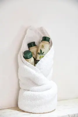 a towel filled with bottles of shampoo and conditioner at Merulana Suite S.Peter in Rome
