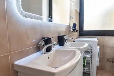a bathroom with two sinks and a mirror at Merulana Suite S.Peter in Rome