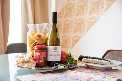 a bottle of wine sitting on a table with food at Merulana Suite S.Peter in Rome