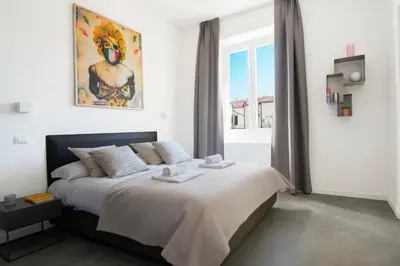 a bedroom with a bed and a window at 1 bdr apartments Ambio Suites Luxury Trastevere in Rome