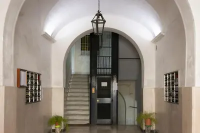 an entrance to a building with a black door at 1 bdr apartments Ambio Suites Luxury Trastevere in Rome