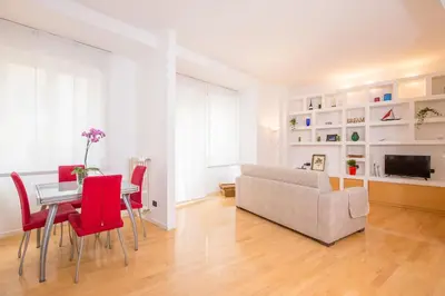 a living room with a table and chairs and a couch at Dream House Vaticano in Rome
